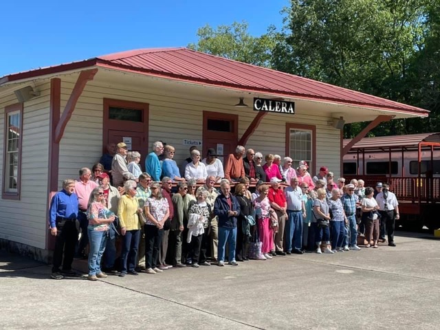 A Charter Group stands by Calera Depot after an Excursion