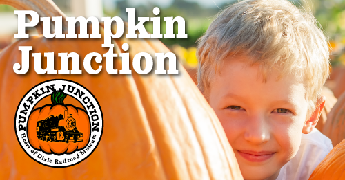 Child peering around a pumpkin.