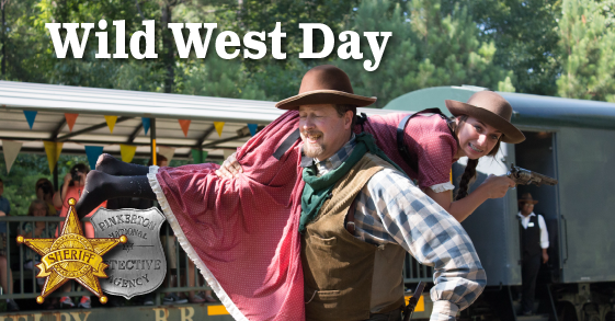 Man in western wear carrying young woman