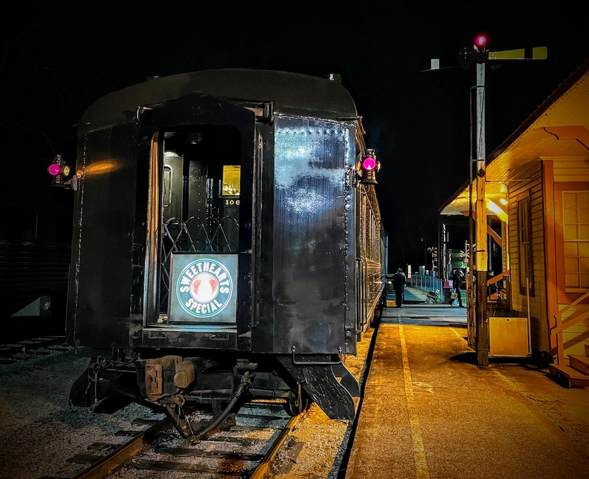 Passenger car at train depot at night.