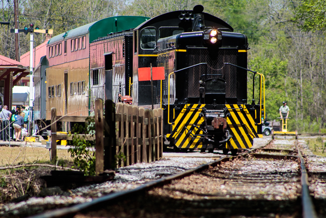 SW8 Locomotive pulling passenger cars.