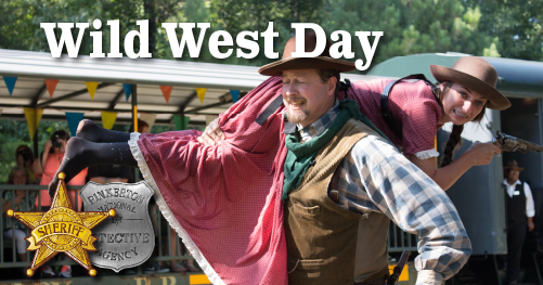 Man in Western wear carrying young girl